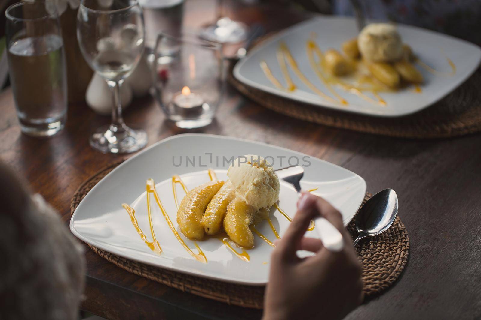 Fried banana and ice cream on a plate.
