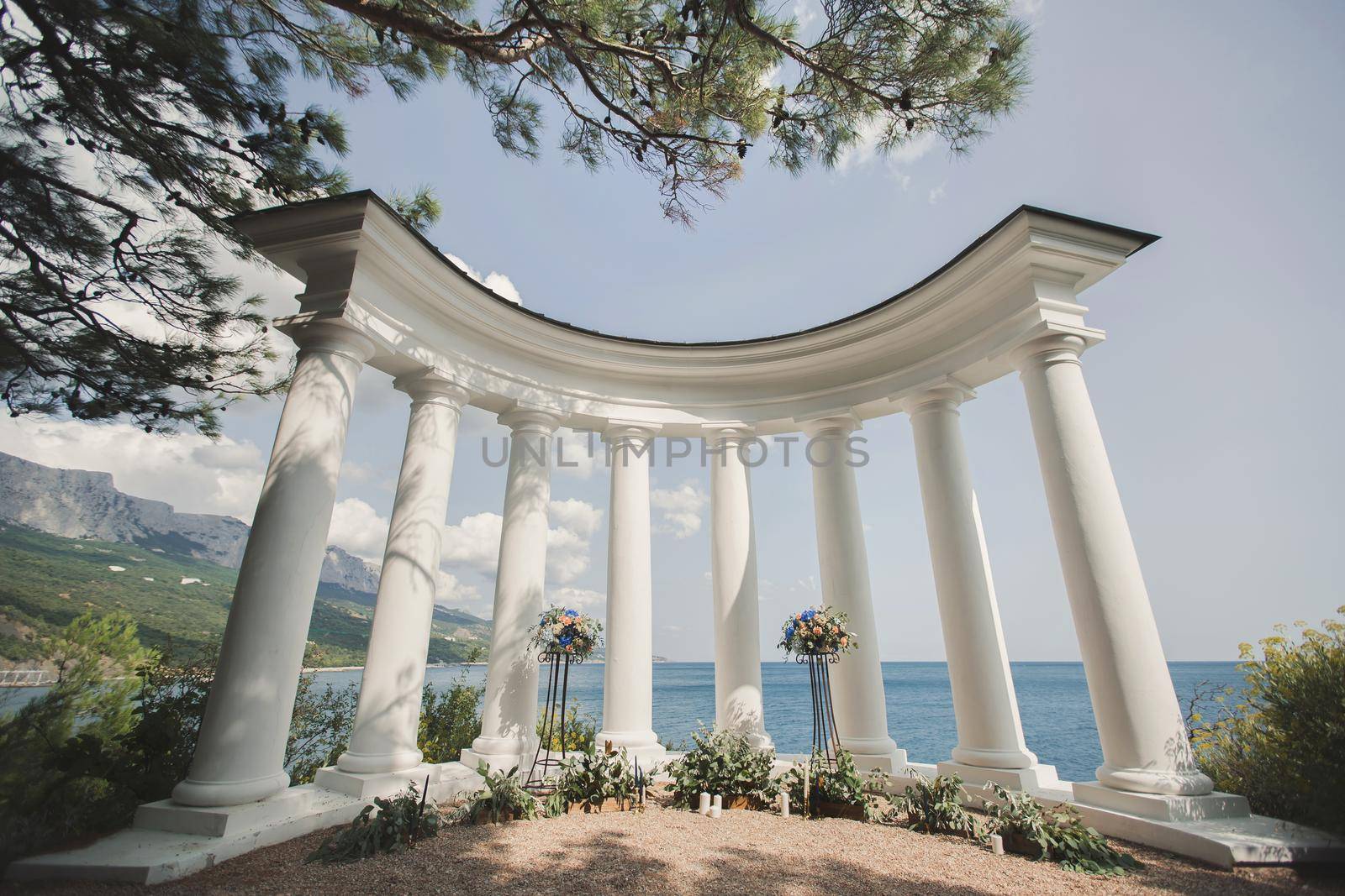 Wedding arch with white columns. Beautiful Wedding Ceremony.