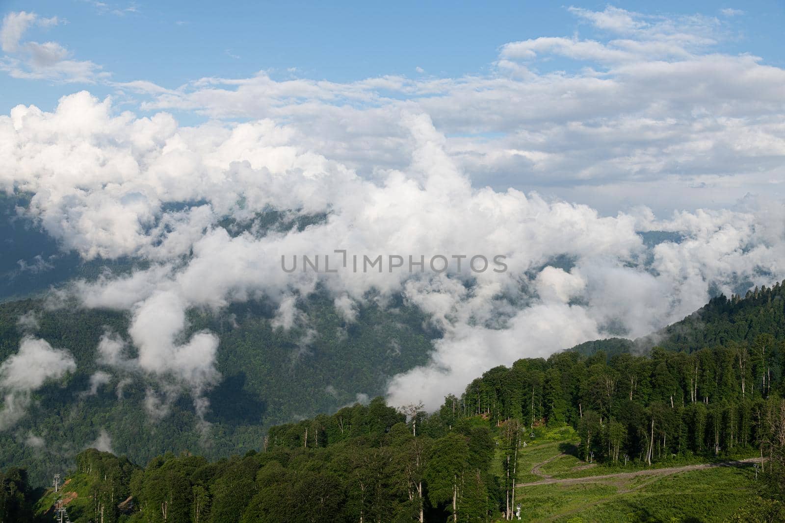 Caucasus mountains with trees and a clouds, Russia