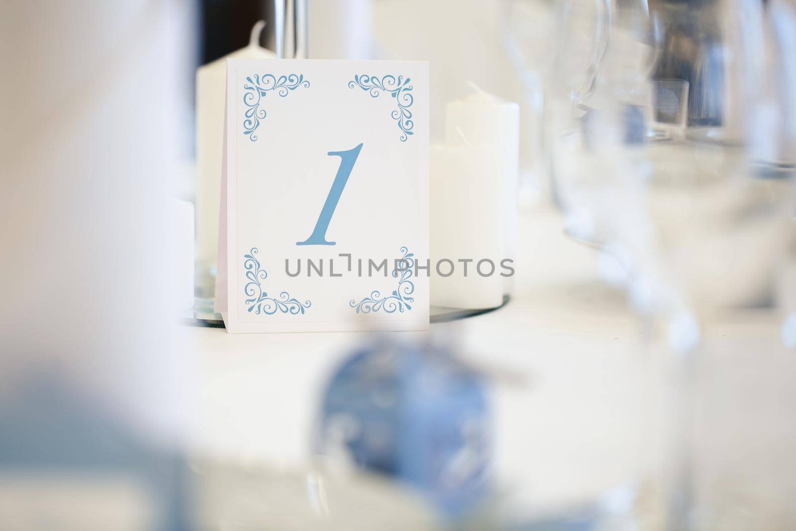 Guest table number. Wedding table in the restaurant by StudioPeace