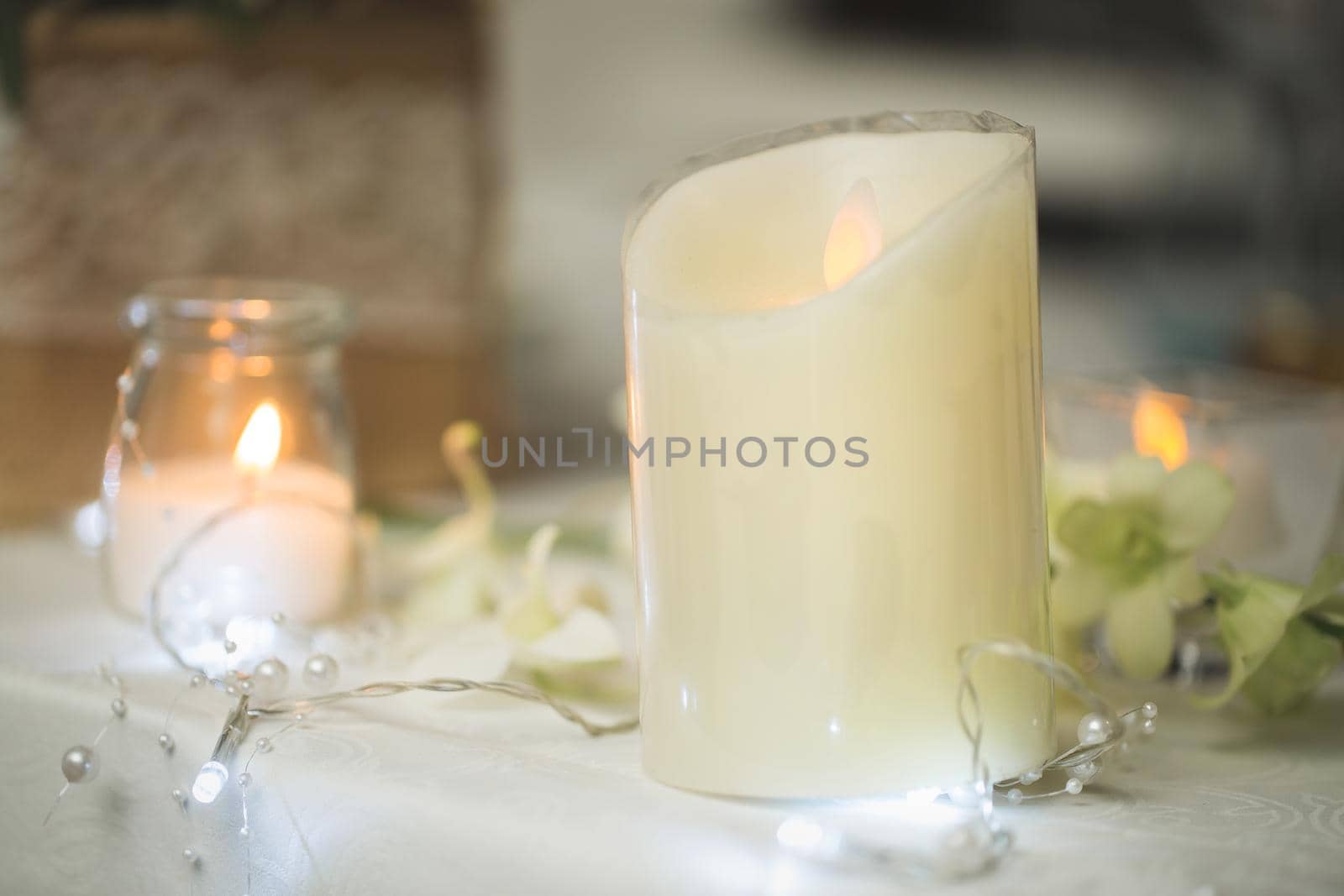 Candles on the wedding table. Delicate decor.