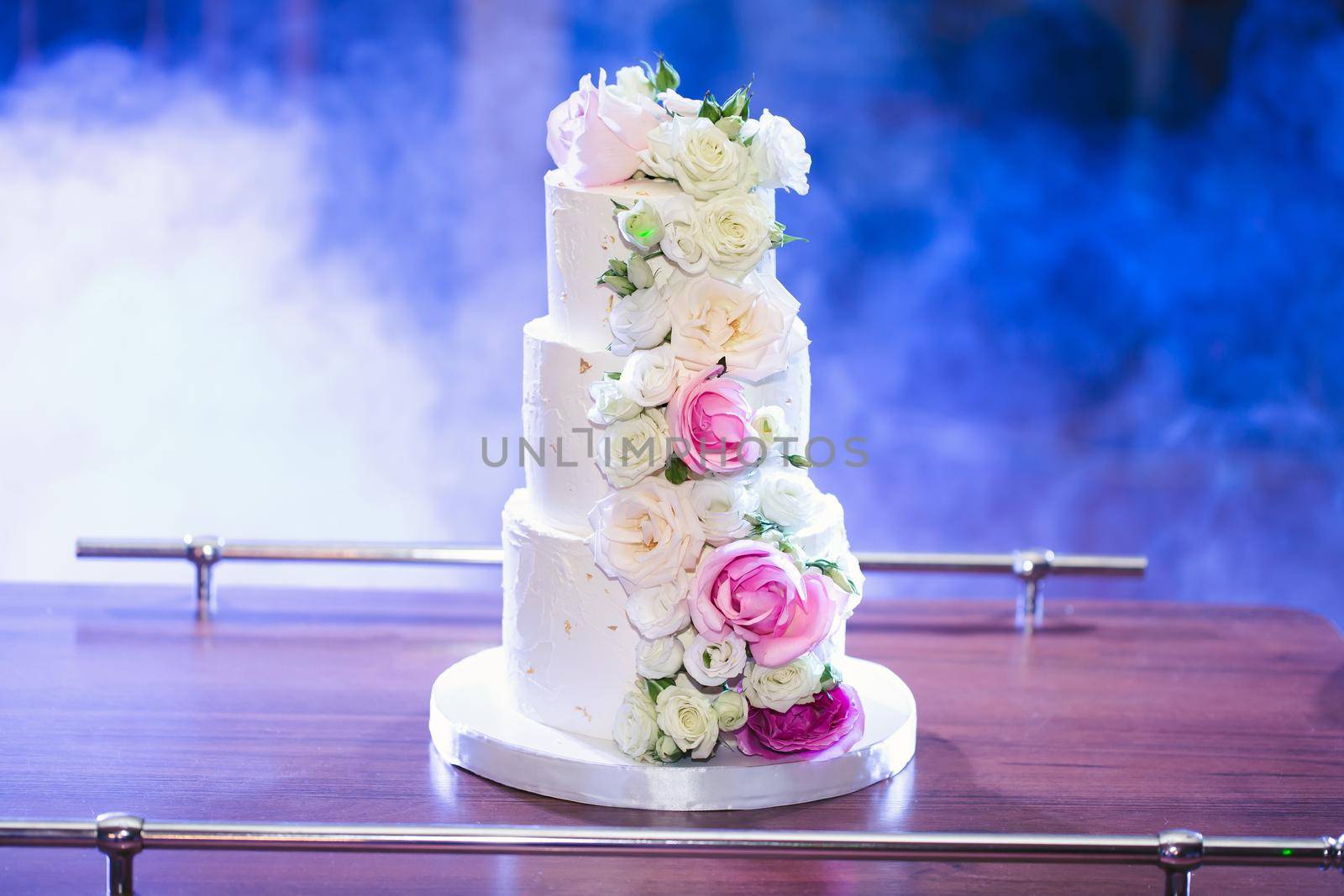 Beautiful wedding cake for the newlyweds at the wedding. A birthday cake at a banquet by StudioPeace