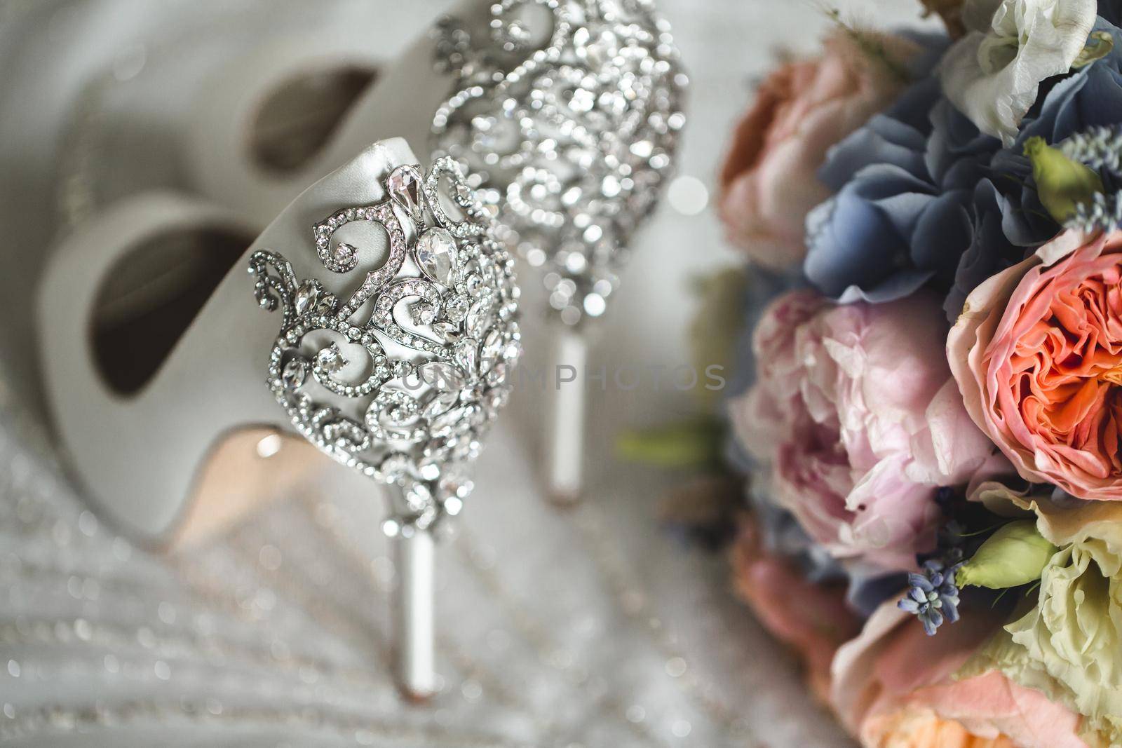 Brides wedding shoes with a bouquet with roses. by StudioPeace