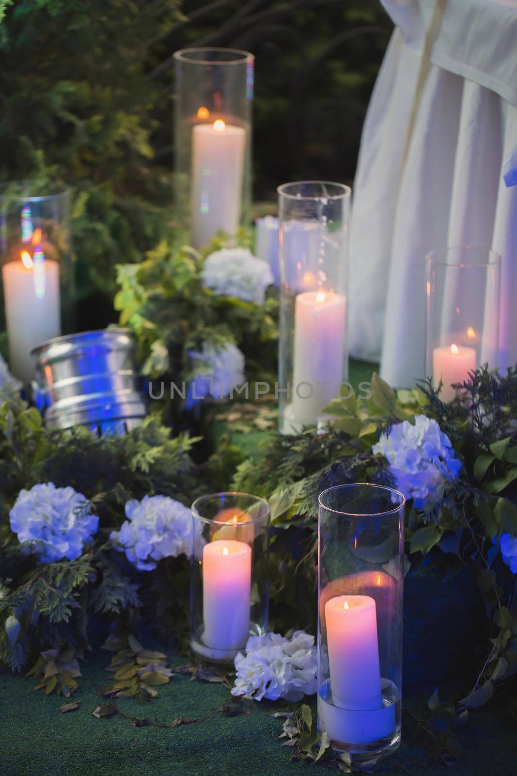 Arrangement of flowers, candles and green plants