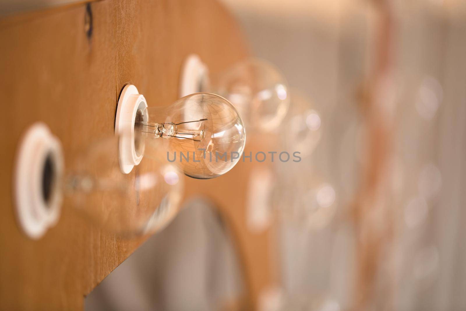 Wooden initials of the bride and groom with bright lights at the wedding by StudioPeace