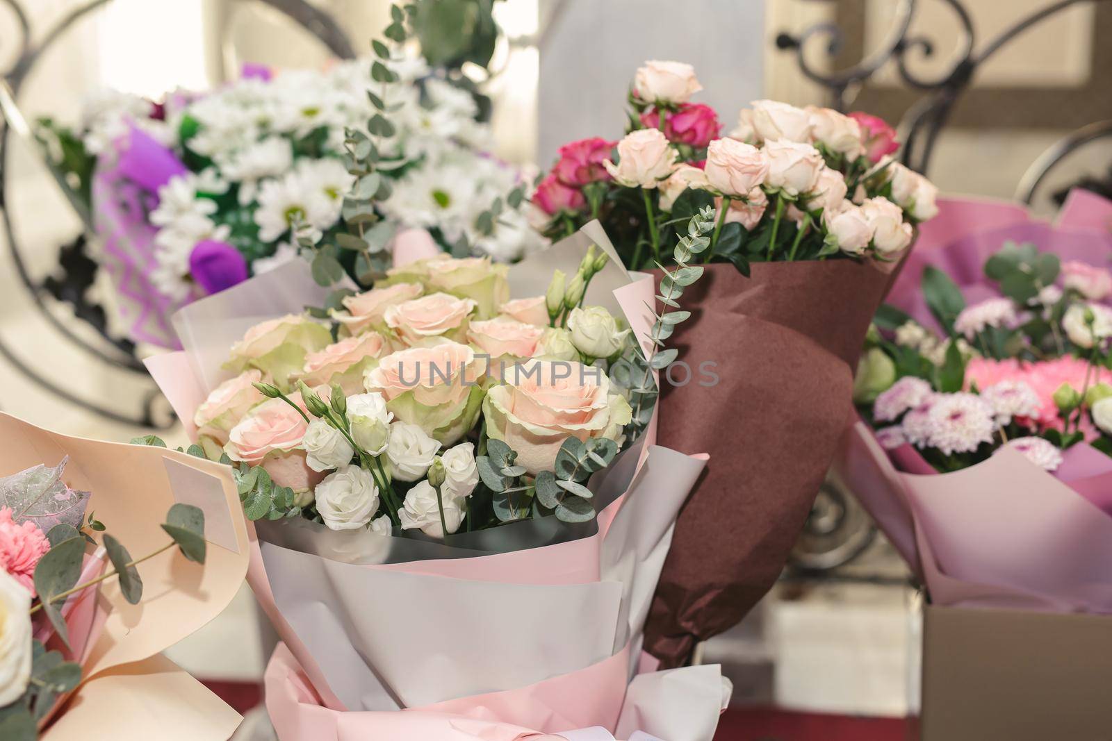 Vases with bouquets of flowers. storage of donated flowers at a banquet in a restaurant by StudioPeace