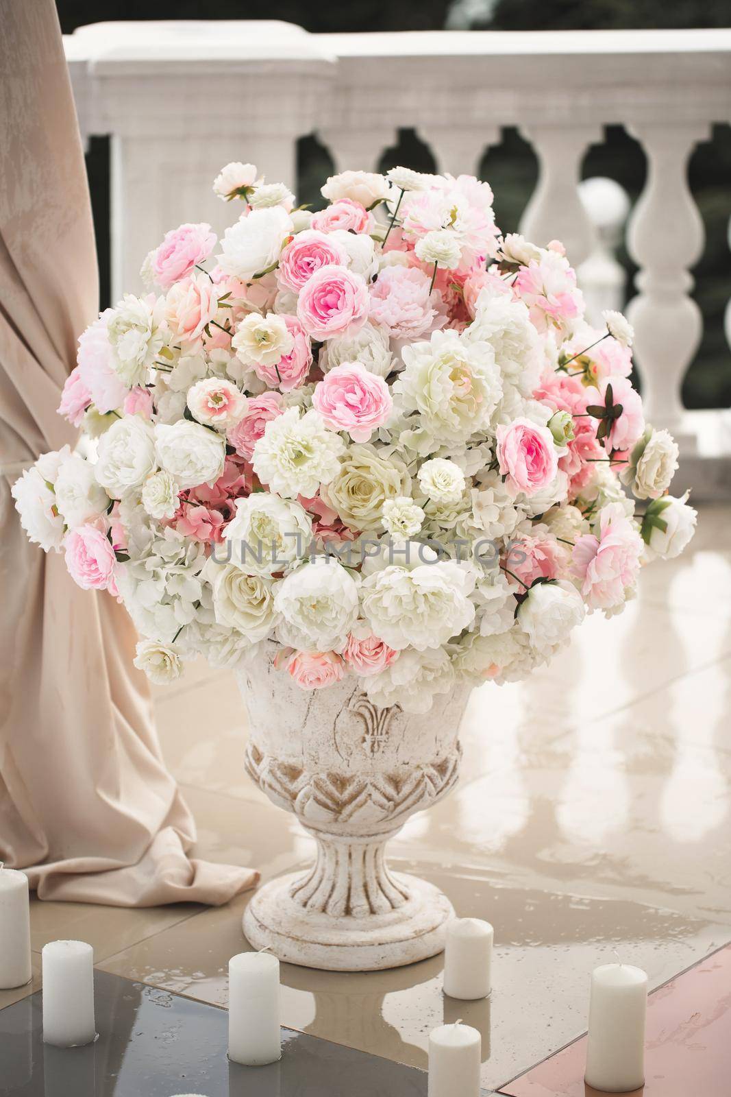 Details. Wedding ceremony in the open air of fresh flowers, with candles. Gentle and beautiful wedding decor for newlyweds.