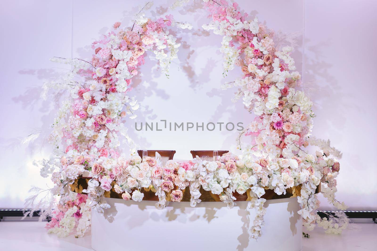 The table of the bride and groom in bright colors. Wedding decor at the banquet.