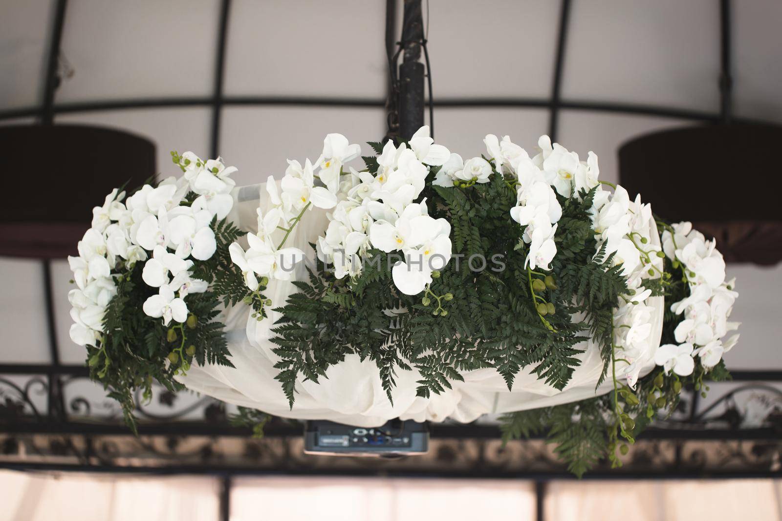 Chandelier of flowers in the restaurant hall by StudioPeace