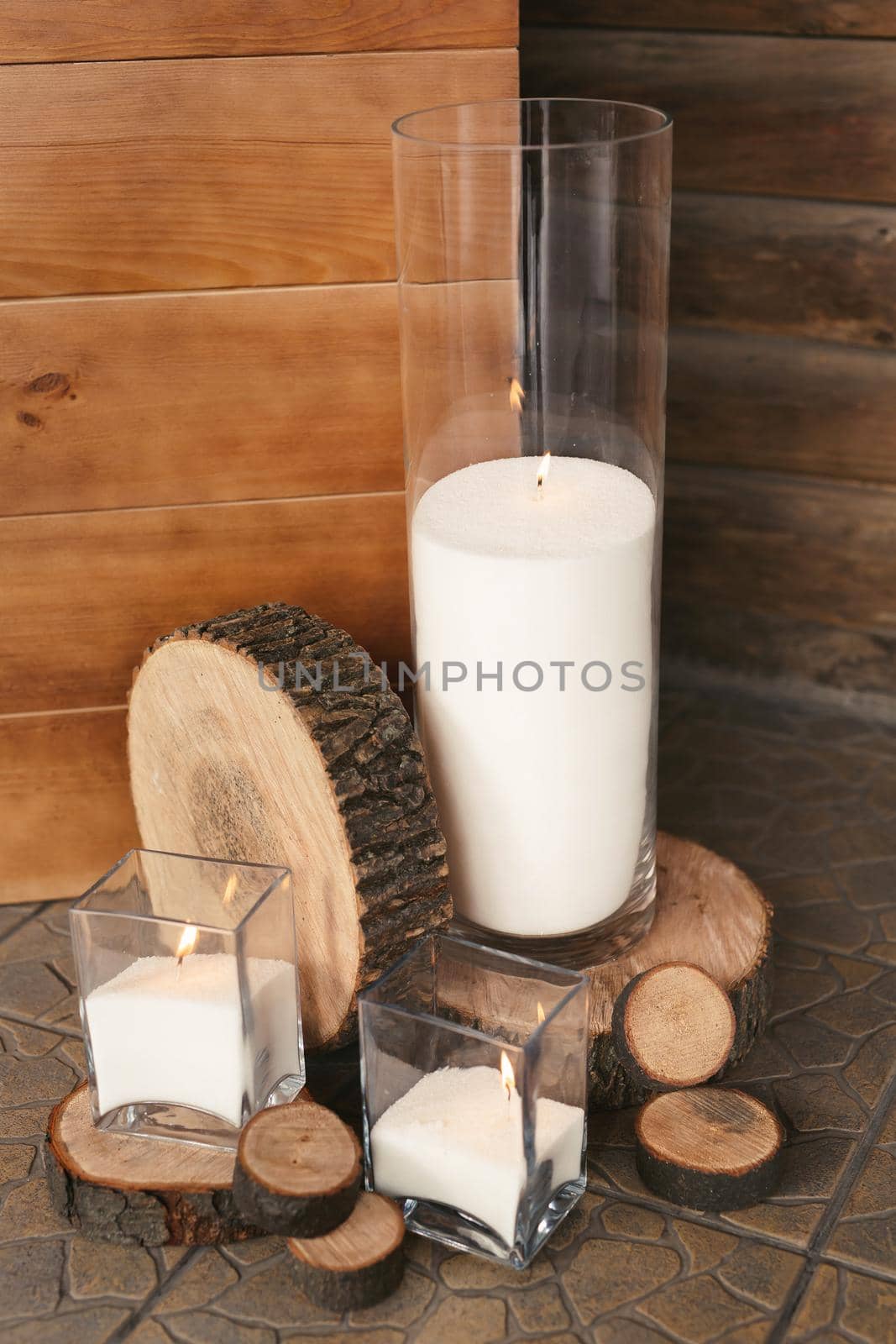Wedding decor at the banquet. Candles and wooden logs.