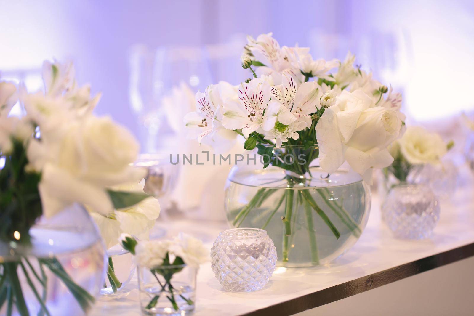 Table setting at a luxury wedding reception. Beautiful flowers on the table.