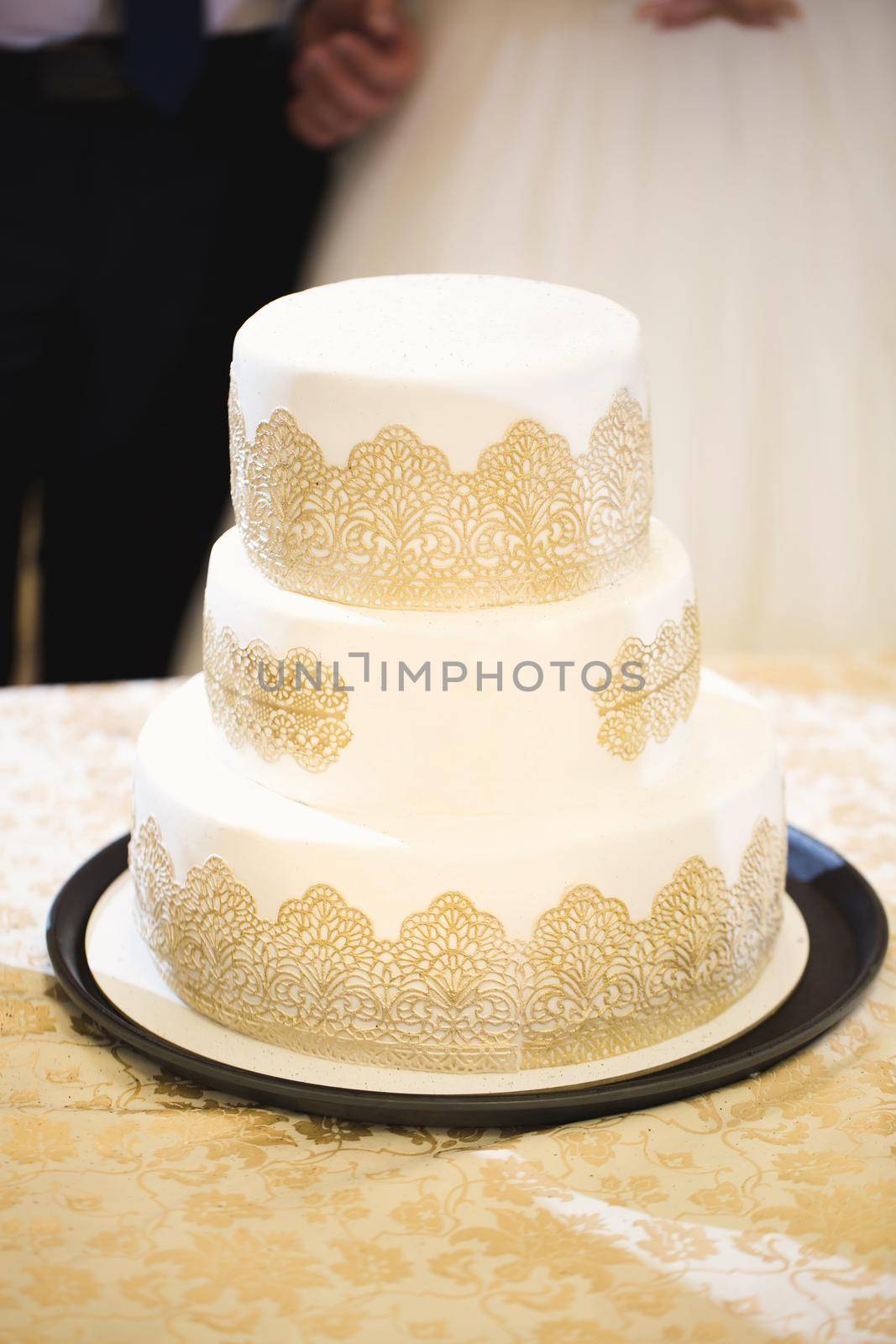 Beautiful wedding cake for the newlyweds at the wedding. A birthday cake at a banquet by StudioPeace