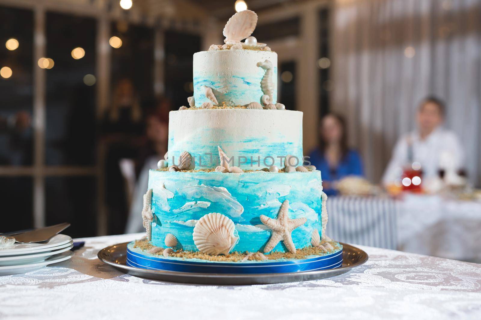 A beautiful wedding cake for newlyweds at a wedding in a nautical style. A birthday cake at a banquet.