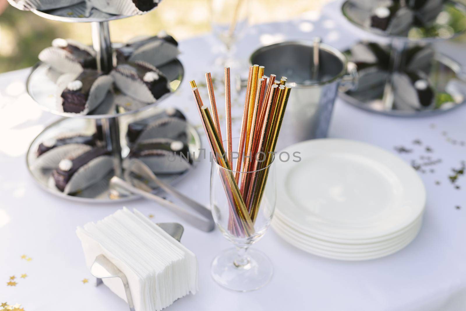 Colorful shiny straws for cocktails on the buffet table by StudioPeace
