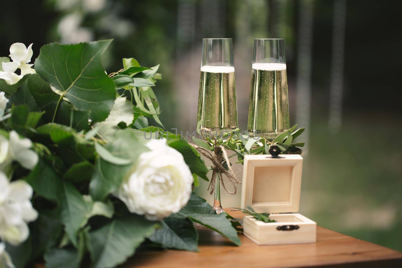 Champagne glasses on the table for registration at the wedding ceremony by StudioPeace