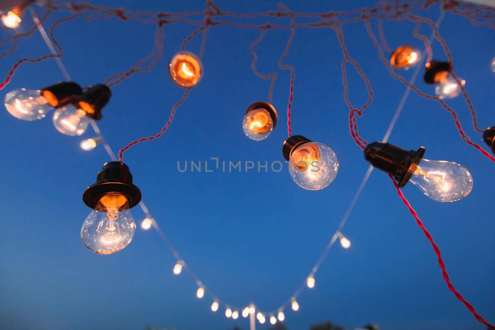 Lights and lights at night against the blue sky. Bokeh. by StudioPeace