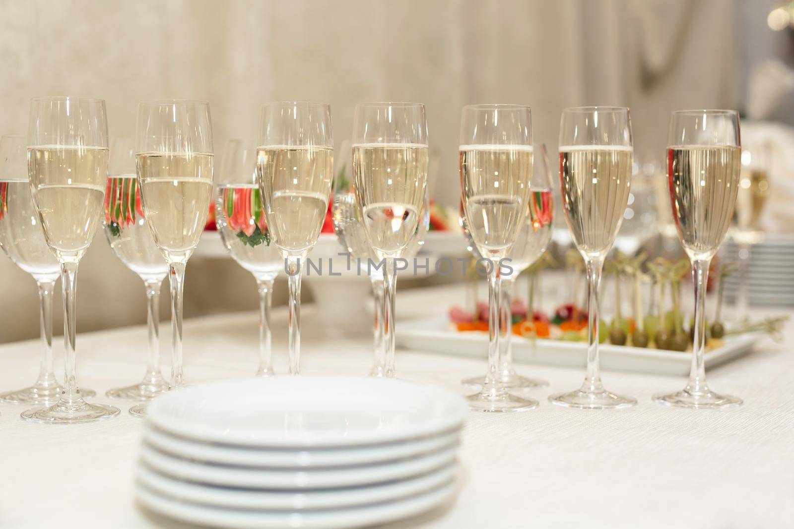 Bride and groom champagne glasses at a wedding reception by StudioPeace