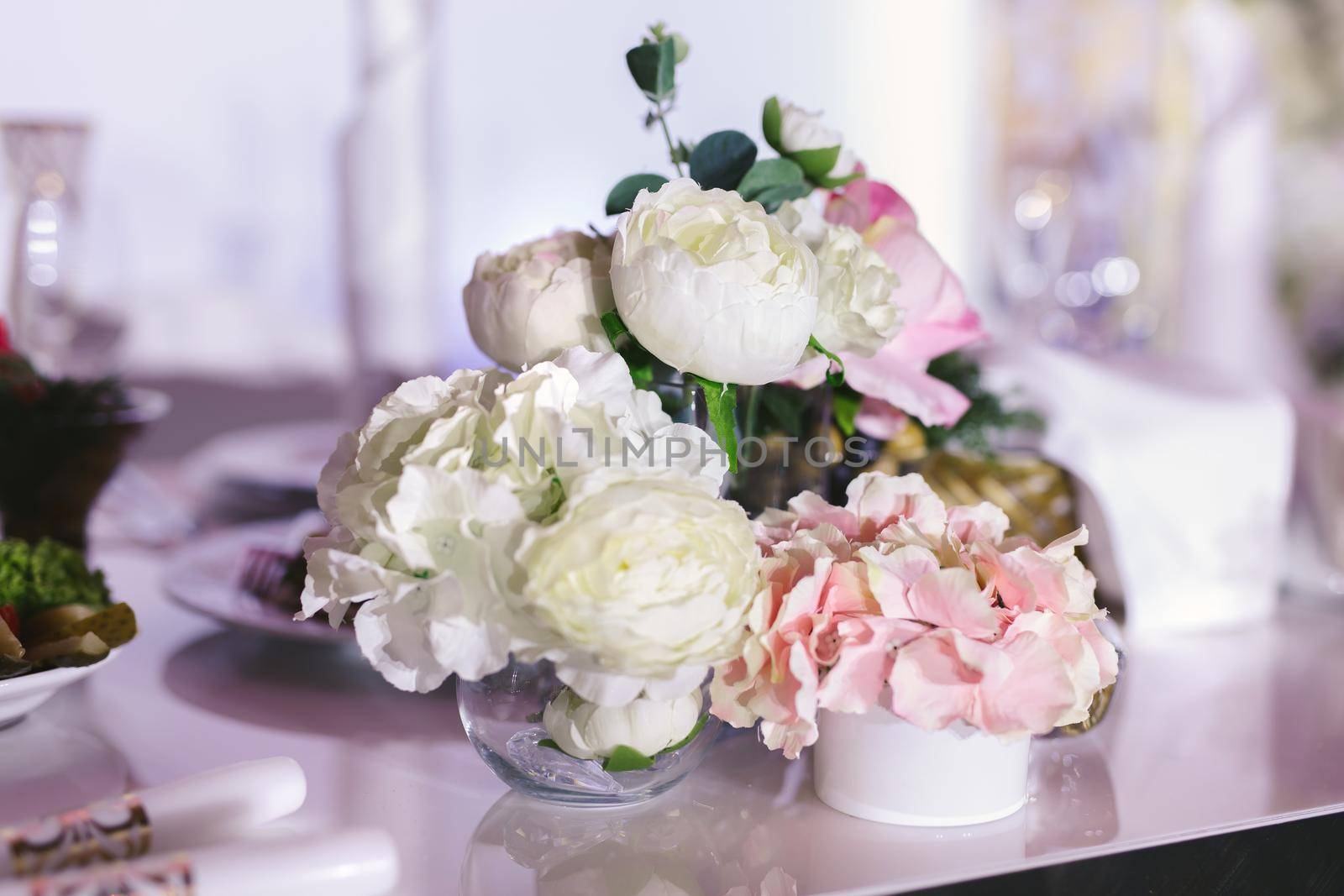 Table setting at a luxury wedding reception. Beautiful flowers on the table.