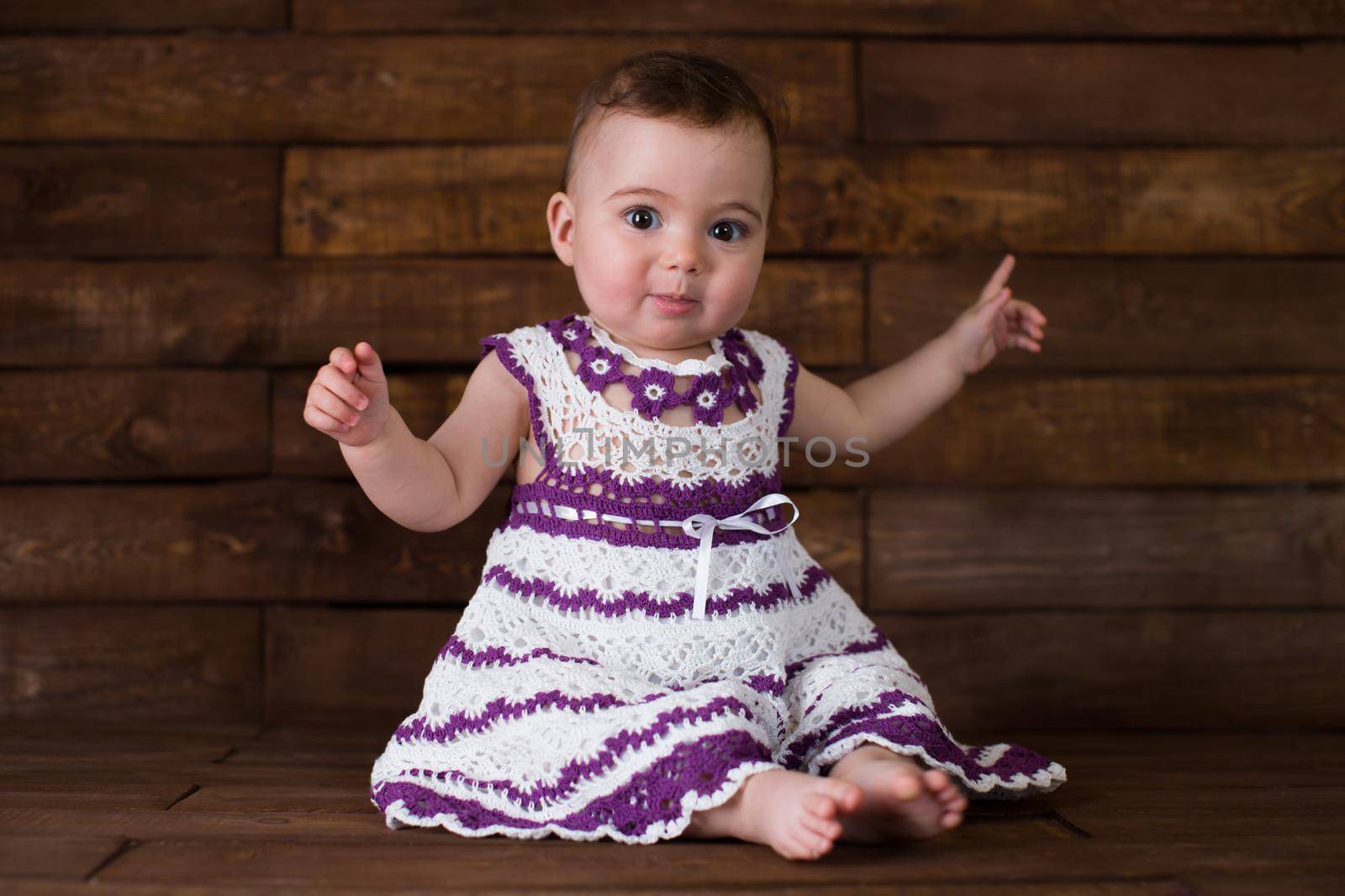 Beautiful girl in pink dress on a wooden background. by StudioPeace