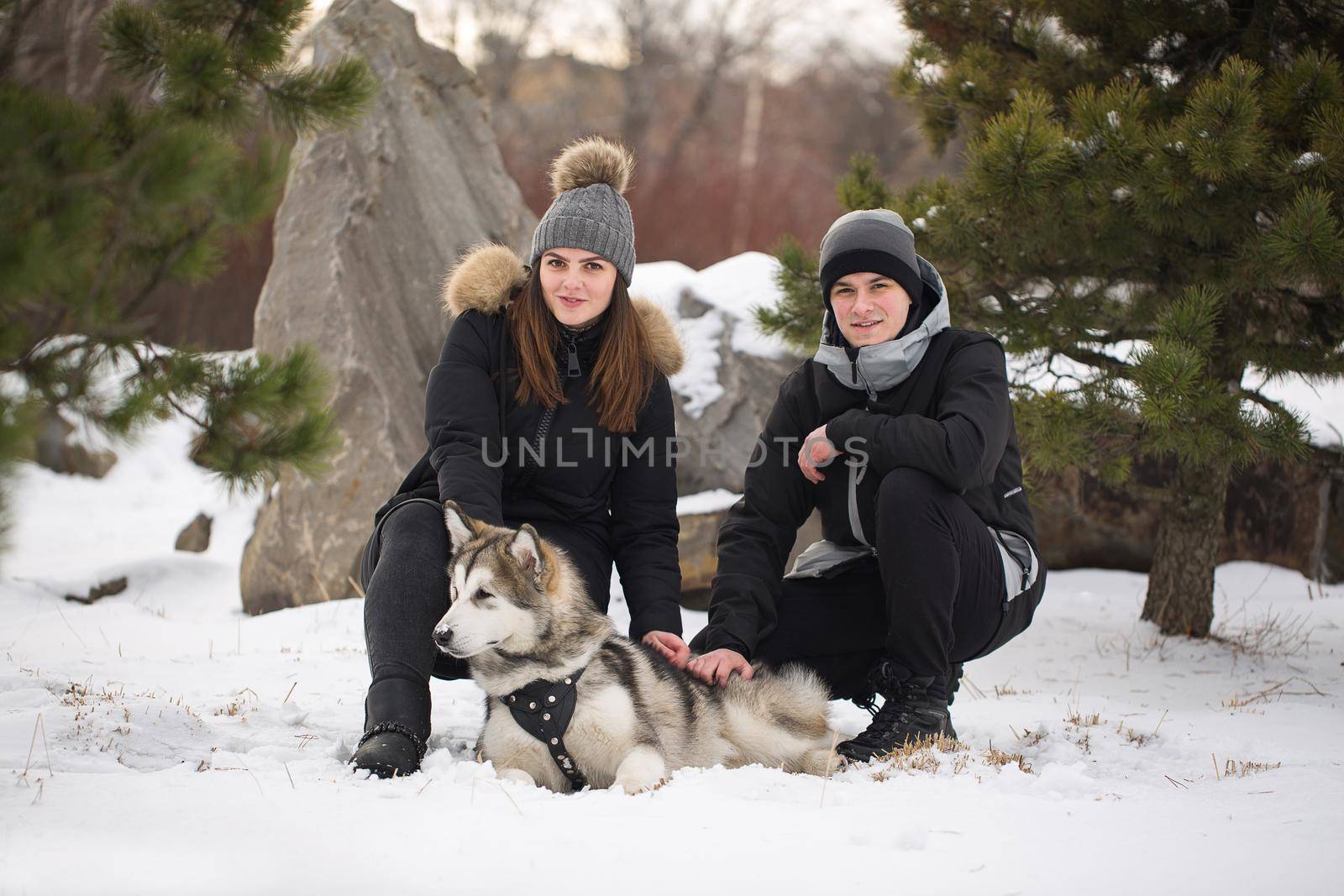 Beautiful family, a man and a girl in winter forest with dog. Play with the dog Siberian husky by StudioPeace