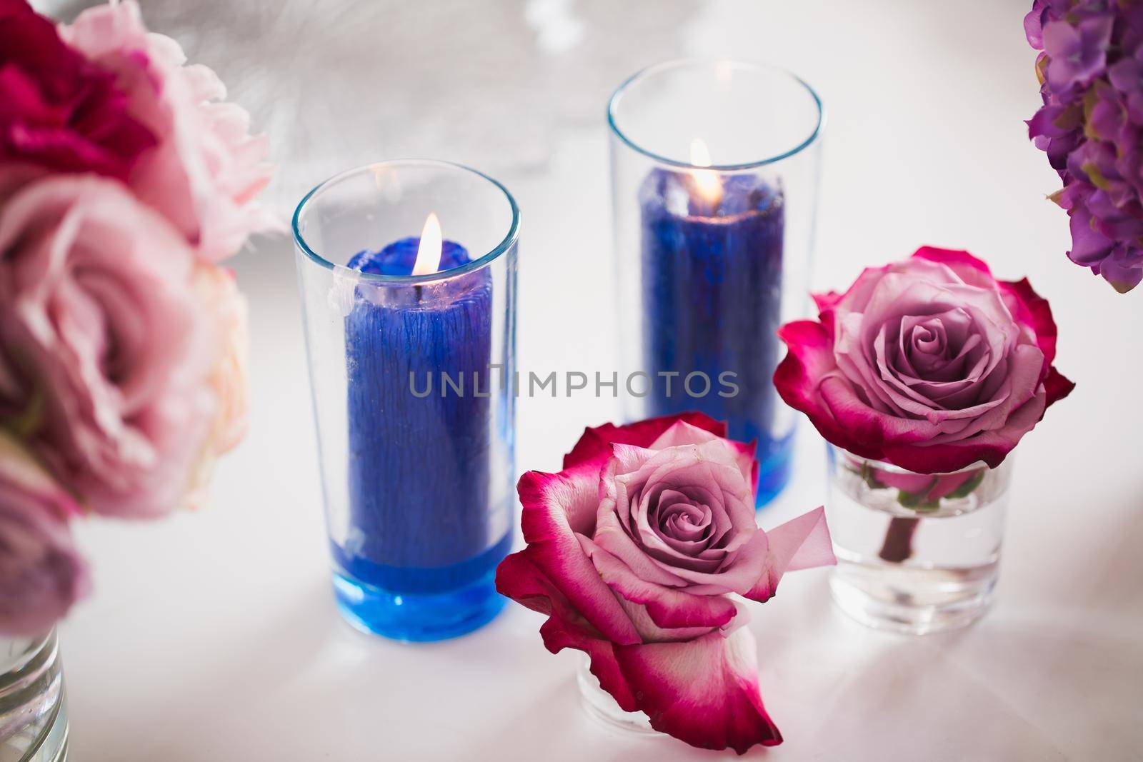 Brightly decorated wedding decor. Beautiful flowers and burning candles.
