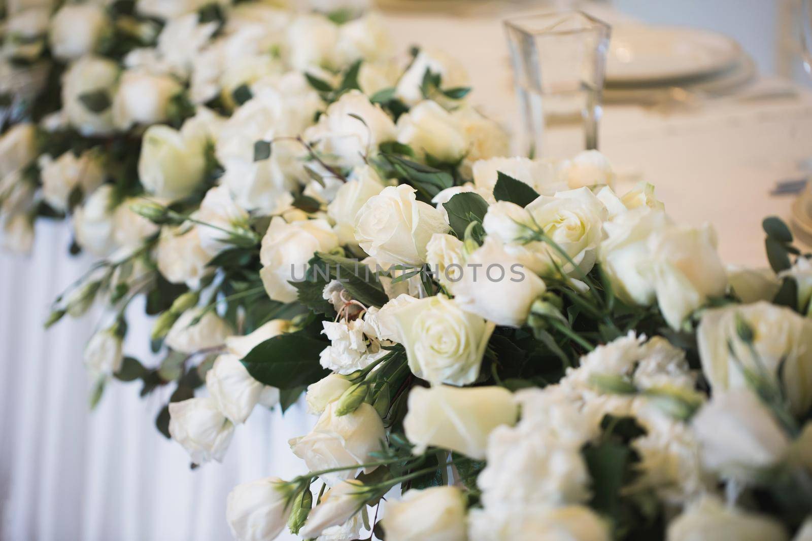 Details. Wedding ceremony in the open air of fresh flowers, with candles. Gentle and beautiful wedding decor for newlyweds.