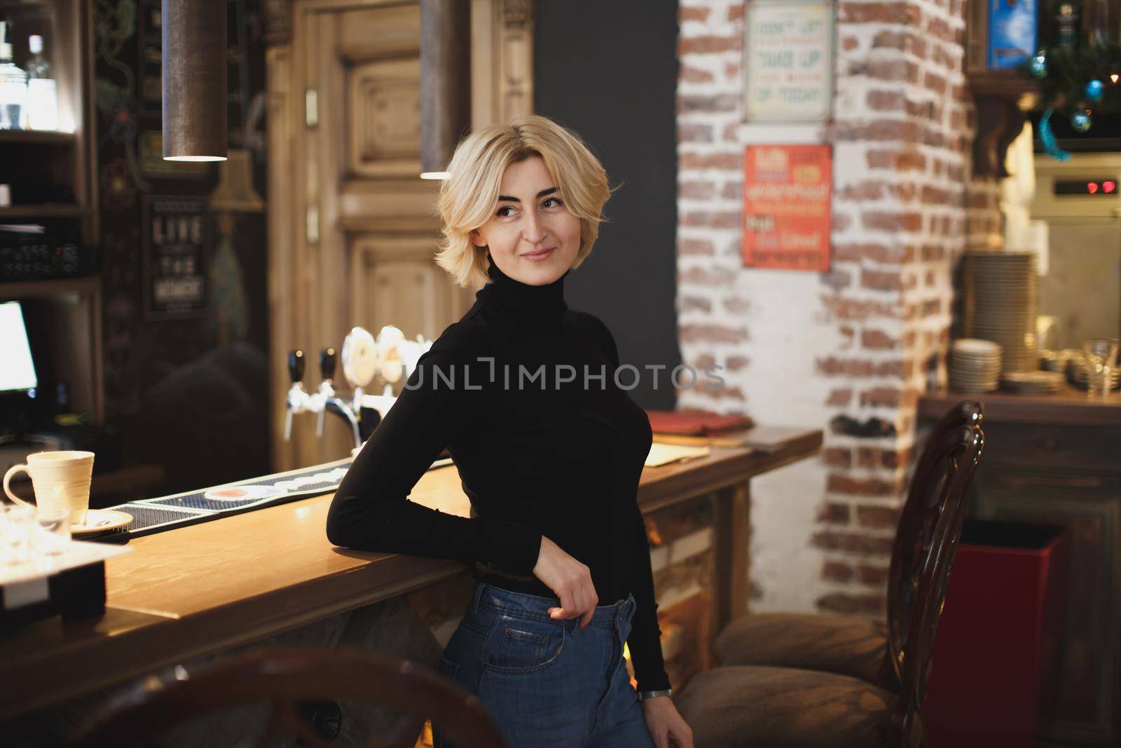 Beautiful woman posing on the bar counter. by StudioPeace