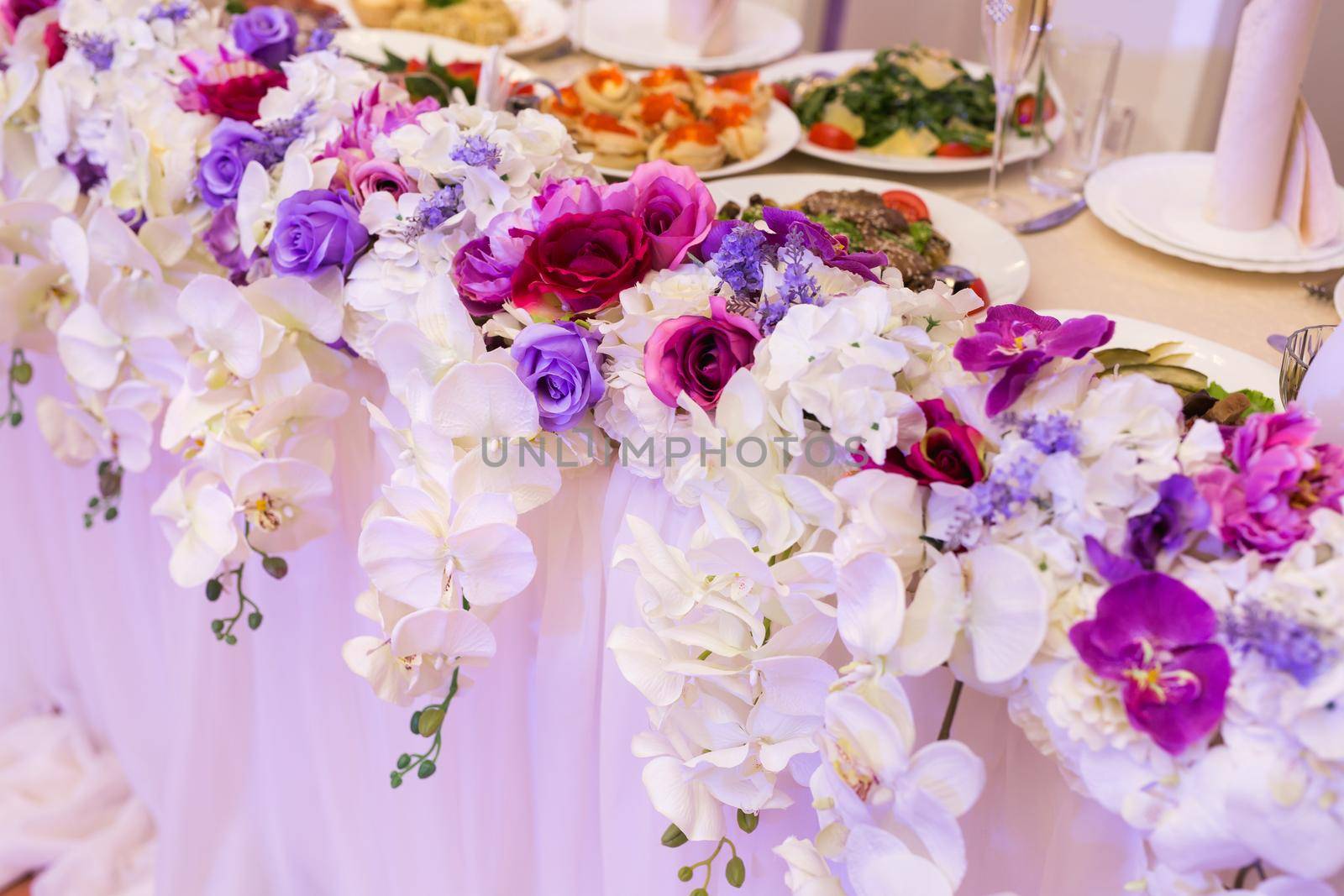 Colorful wedding bouquet of orchids on the restaurant table by StudioPeace