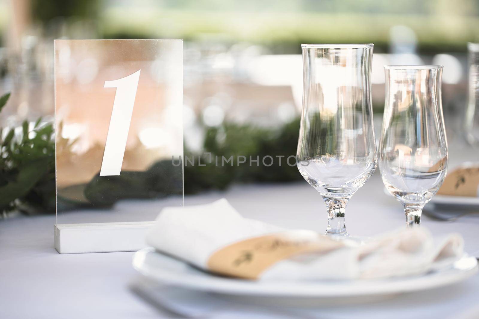 Guest table number. Wedding table in the restaurant by StudioPeace