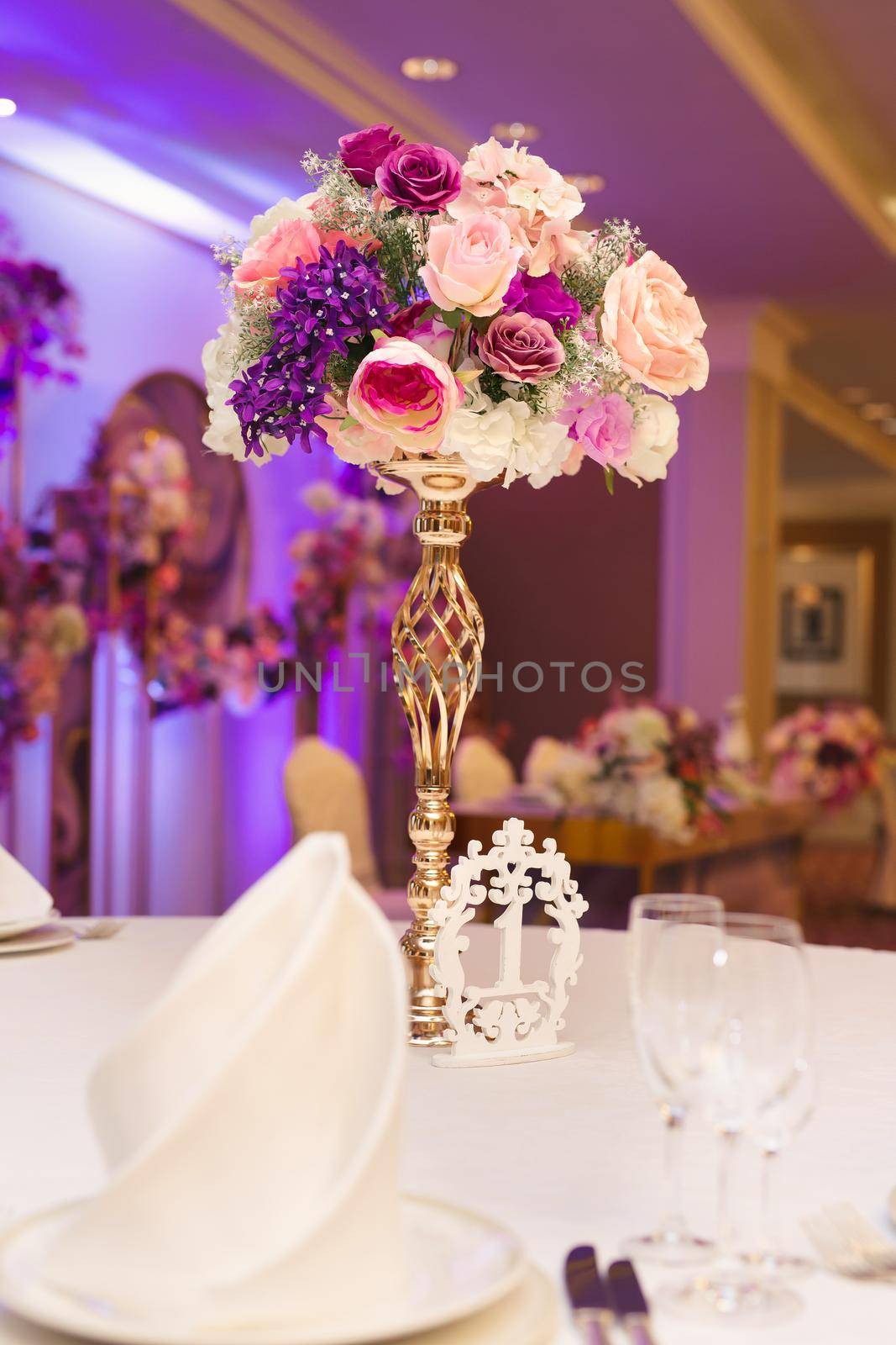 Beautiful wedding table setting with gold, flowers and beads.