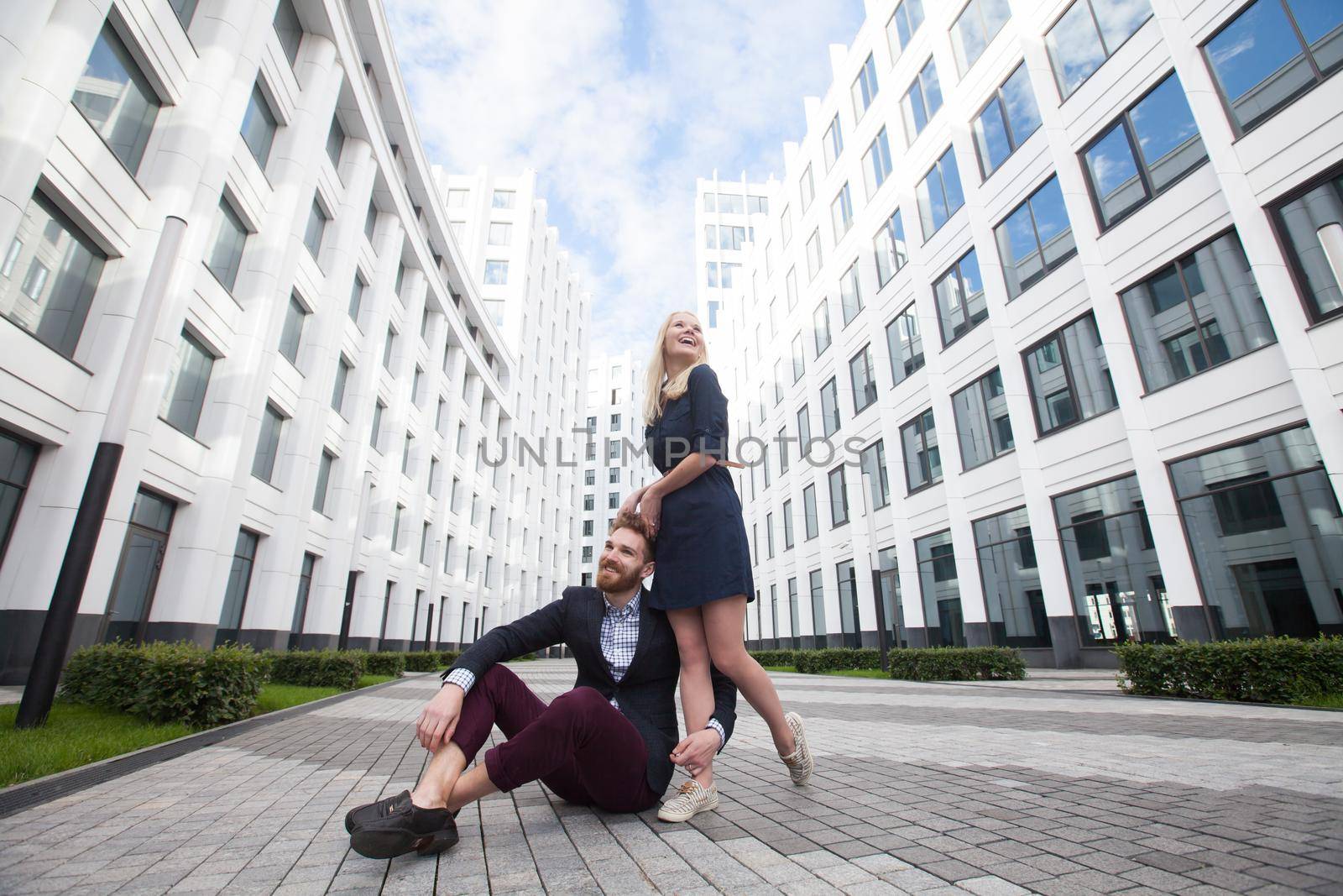 Young couple man and woman on background of office building by StudioPeace