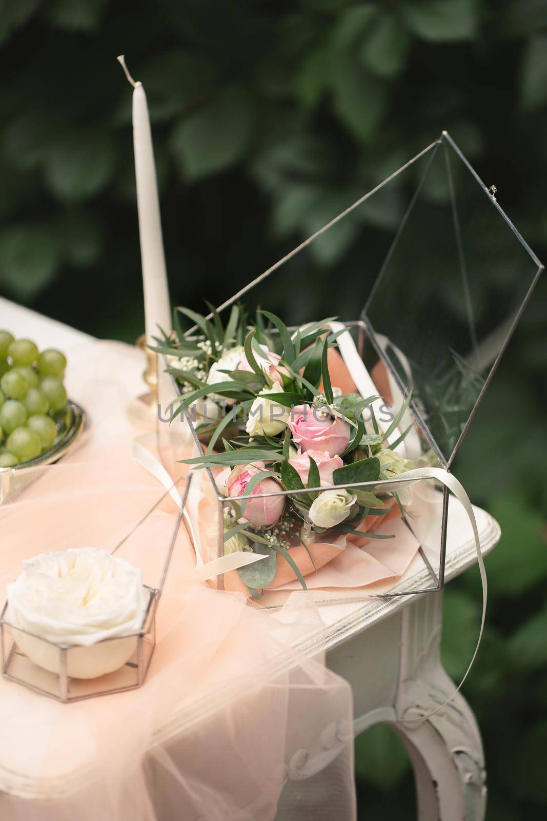 Still life morning of the bride, a dish with a cup of tea, a jewelry box, wedding rings and a bouquet of flowers