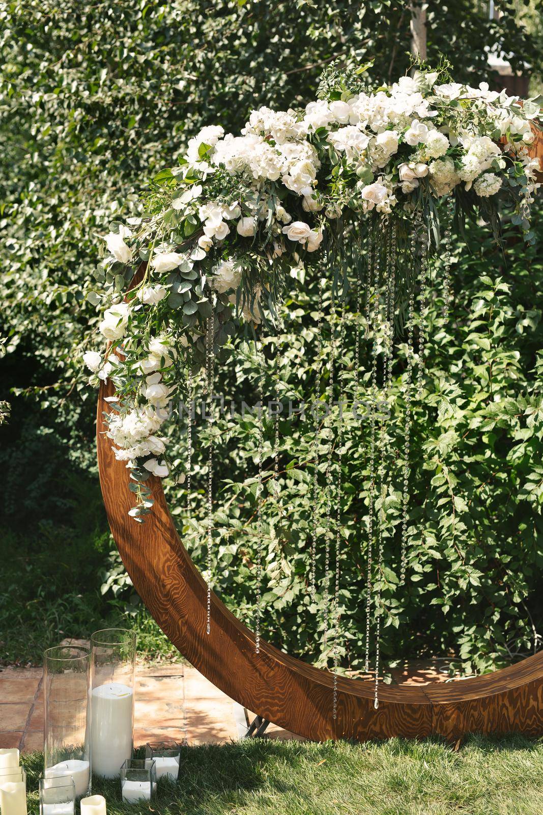 circle wedding arch with flower petals and candles