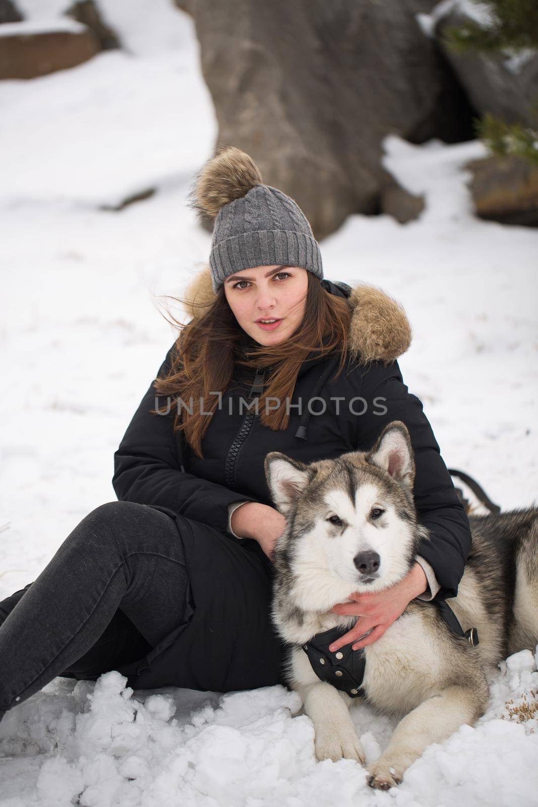 Beautiful girl in winter forest with dog. Play with the dog Siberian husky by StudioPeace