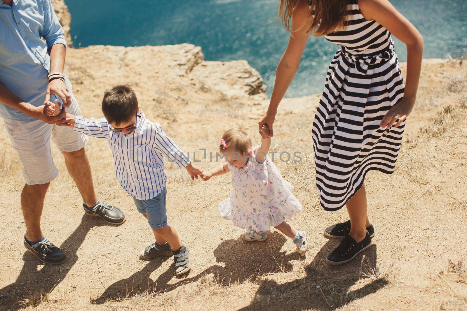 Happy family of four walking in the mountains. Family concept. Family trip.