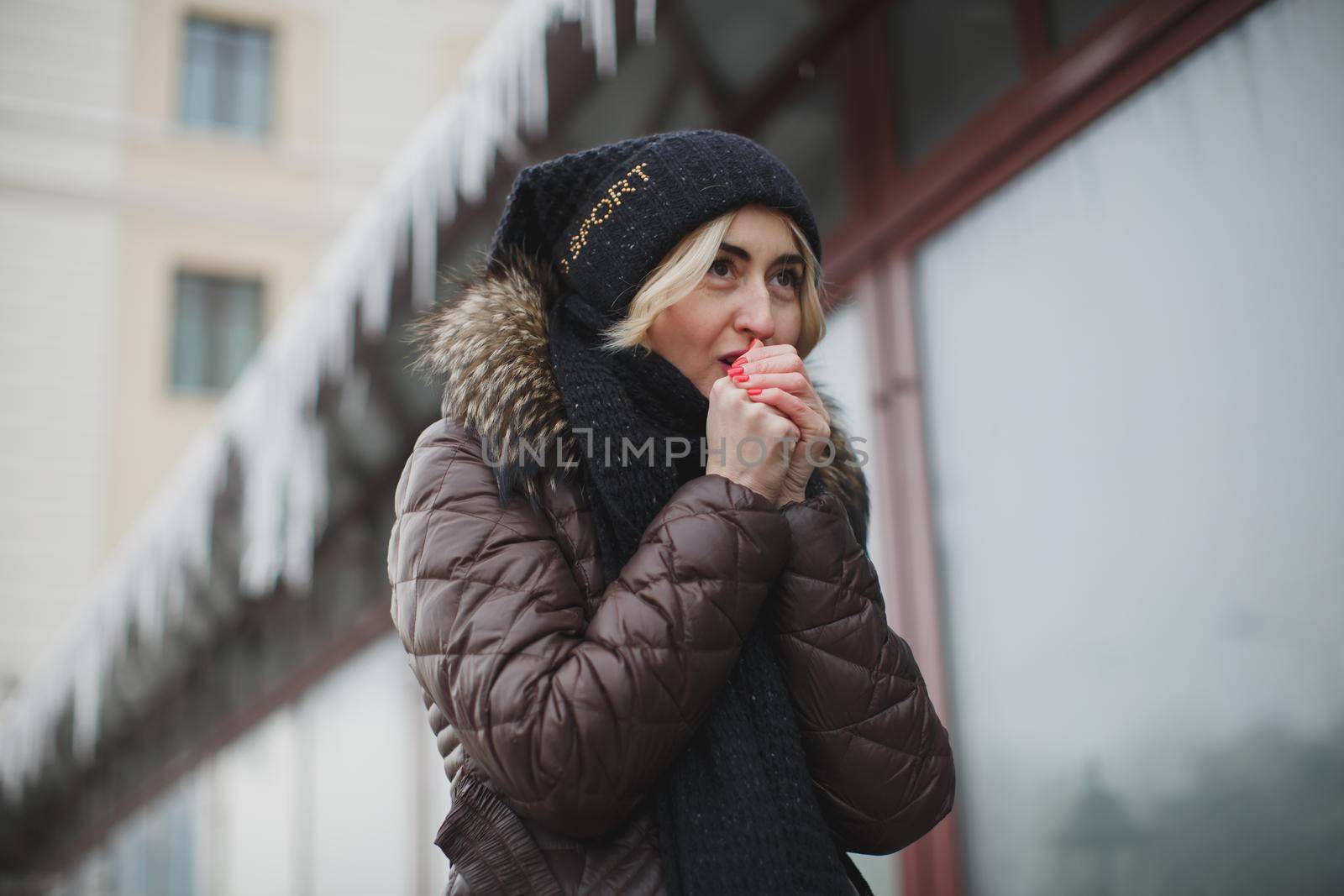 portrait of beautiful happy smiling woman posing outdoors in winter.