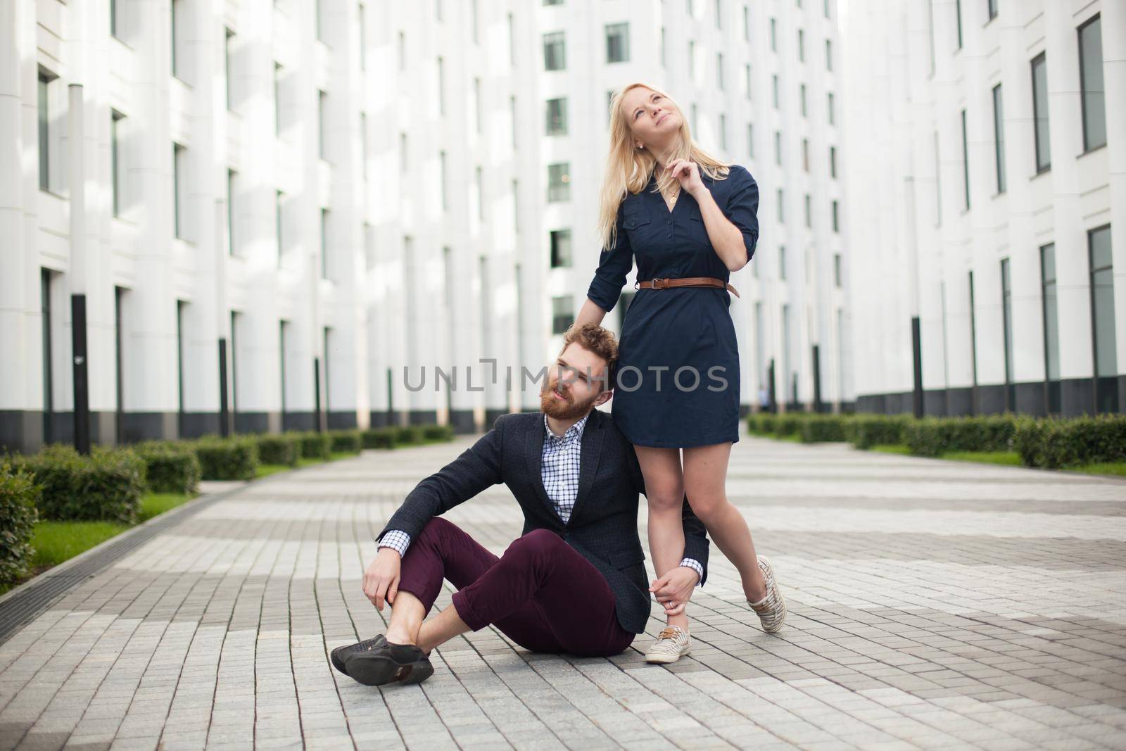 Young couple man and woman on background of office building.