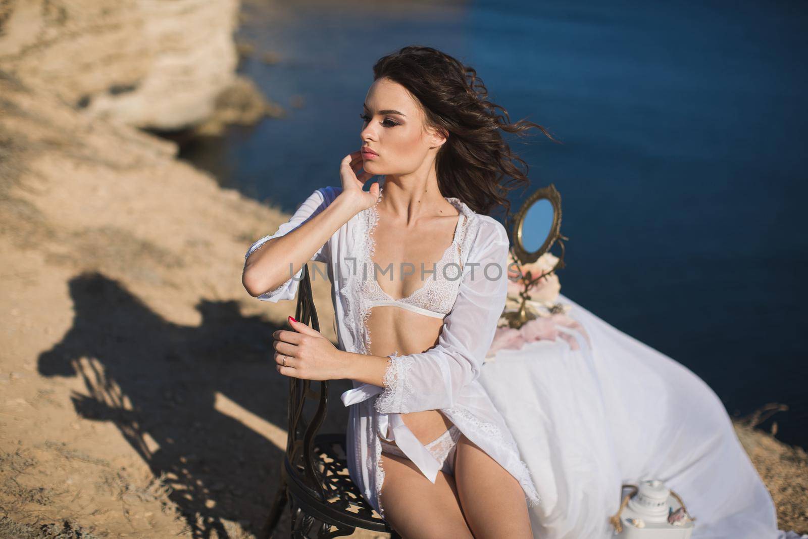 Girl in lingerie on top of a mountain overlooking the ocean. Charges of the bride, bride's morning by StudioPeace