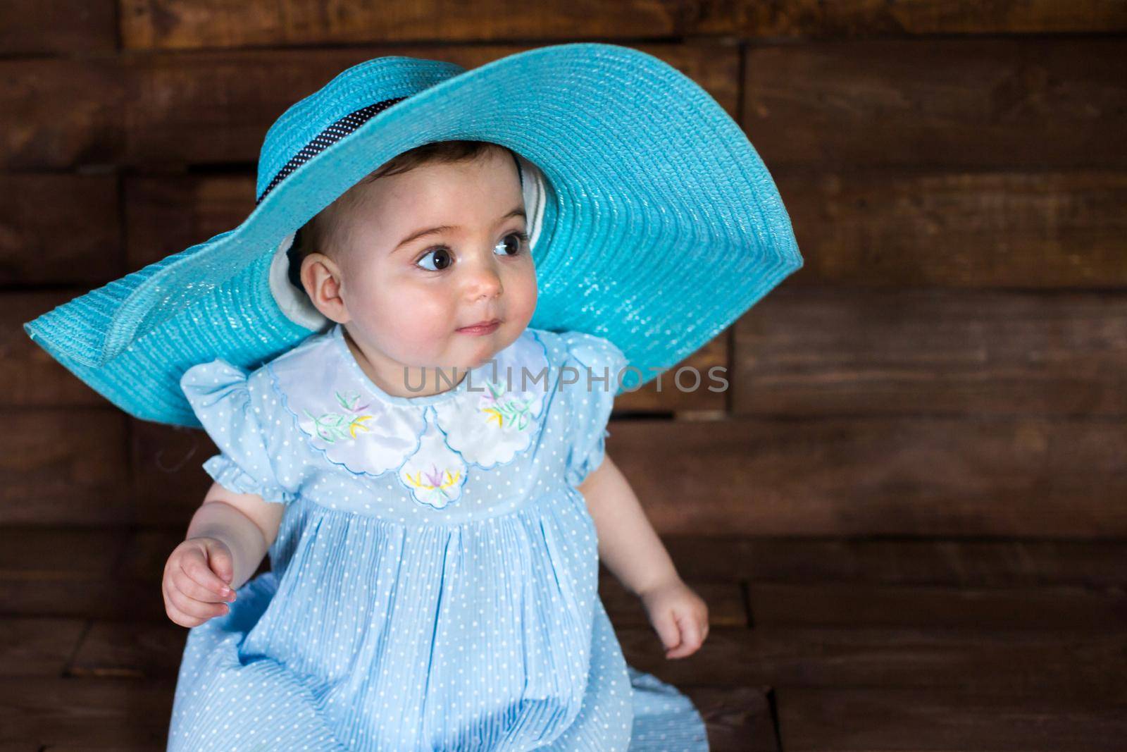 Beautiful girl in blue dress on wooden background