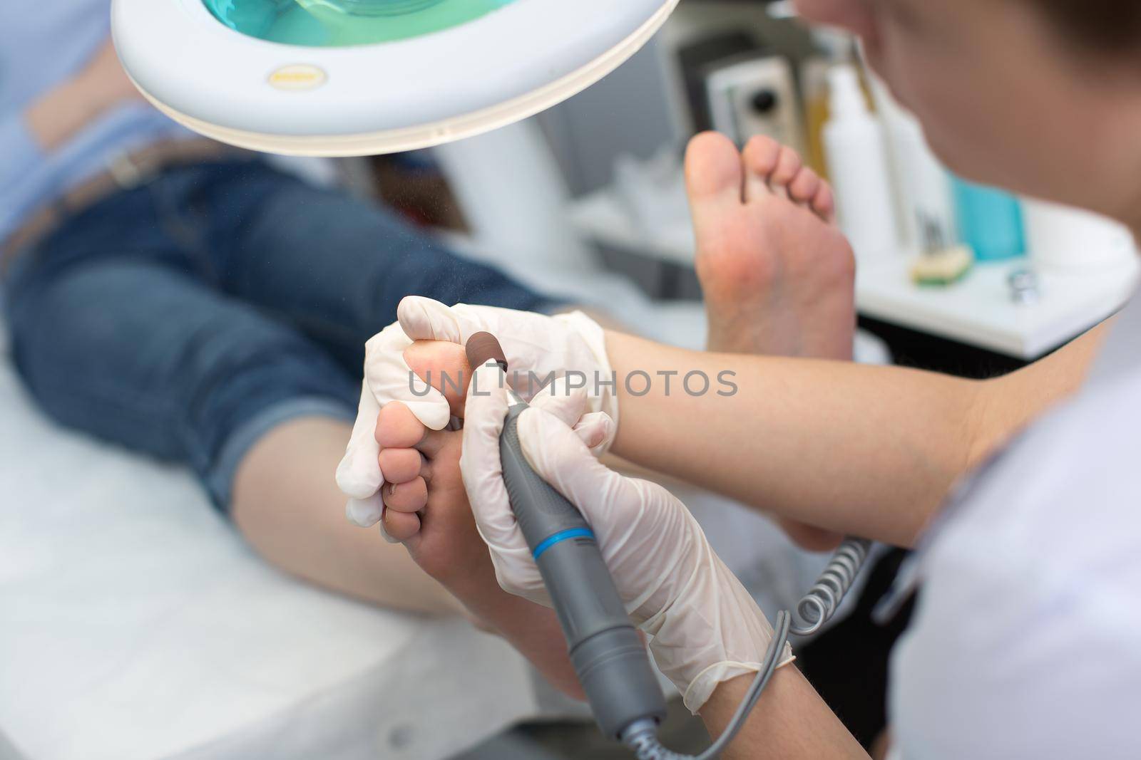 Pedicure SPA procedure in the beauty salon. Peeling feet pedicure procedure. Electric apparatus for pedicure. by StudioPeace