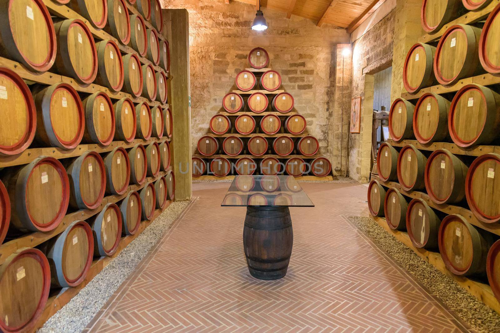 Wooden barrels and a table in a wine cellar