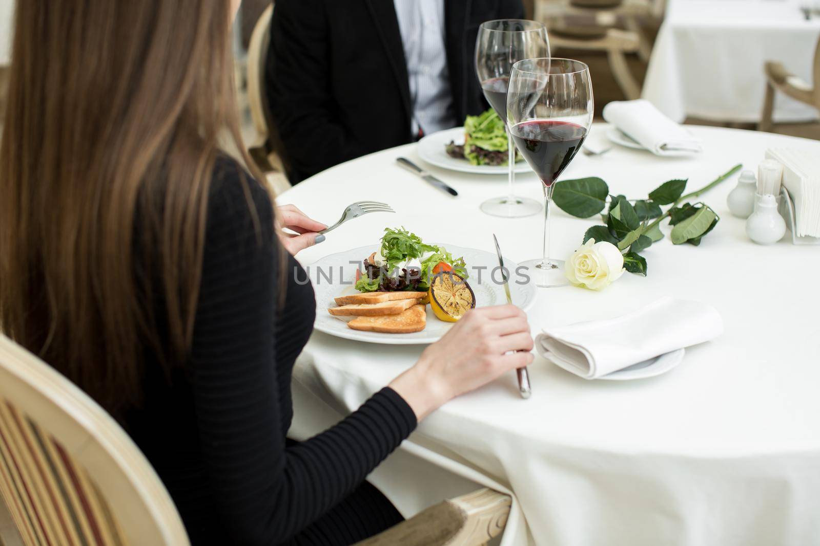 A young couple is having dinner at a restaurant