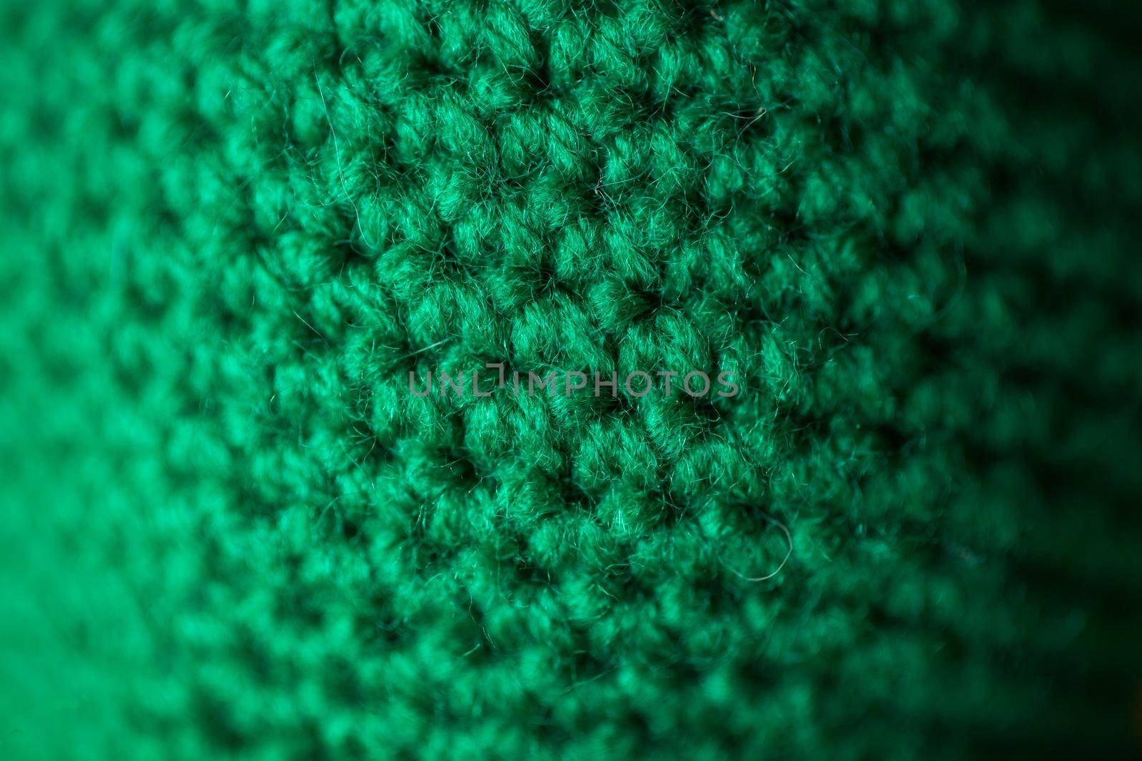 Green knitted wool texture can use as background.