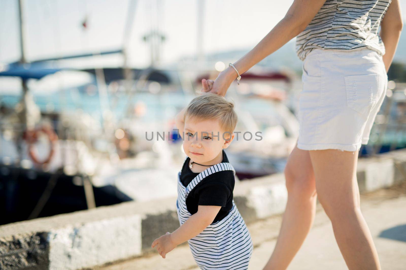 Happy mother and son on sea yacht background