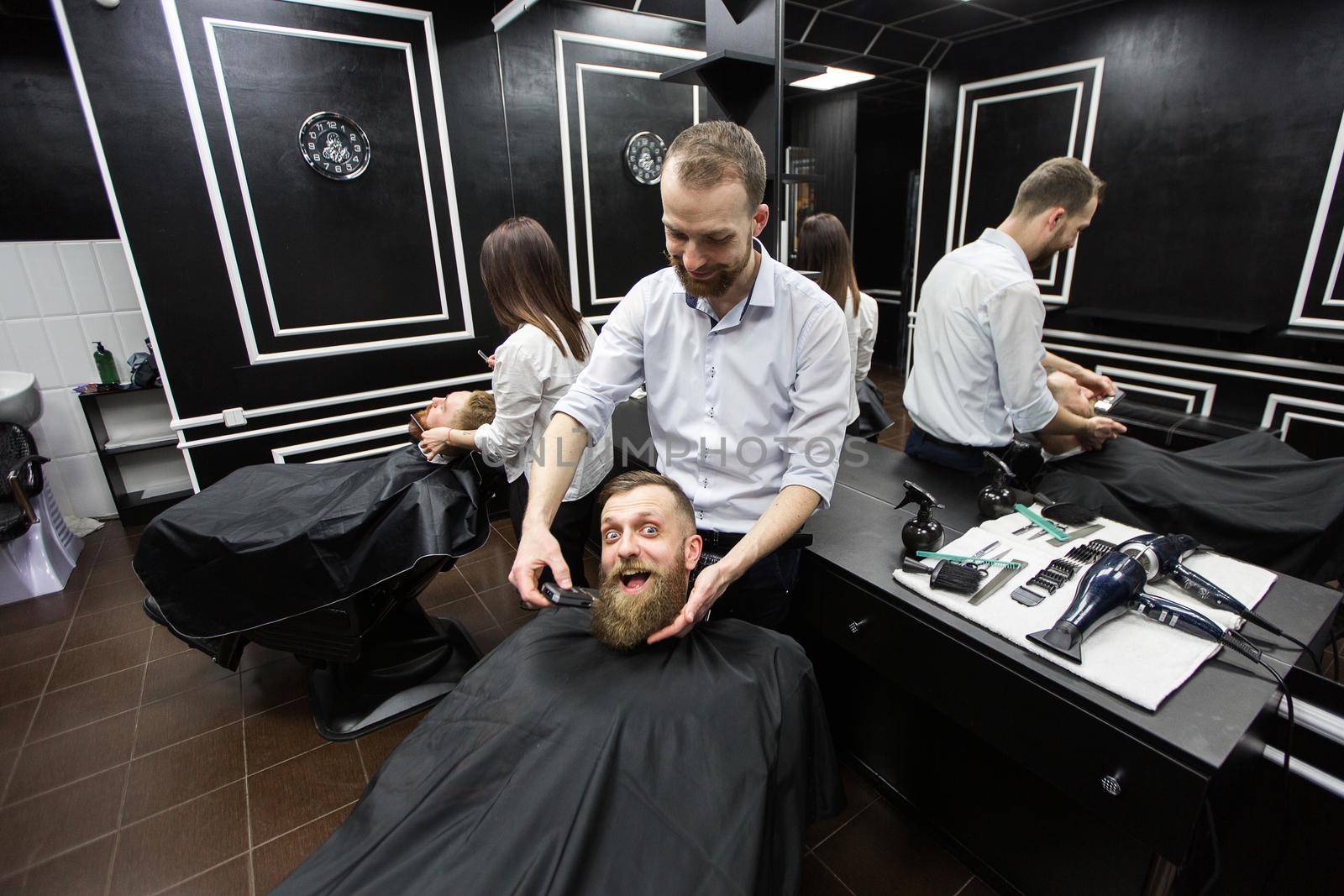 Work in a barbershop. Two masters at work.