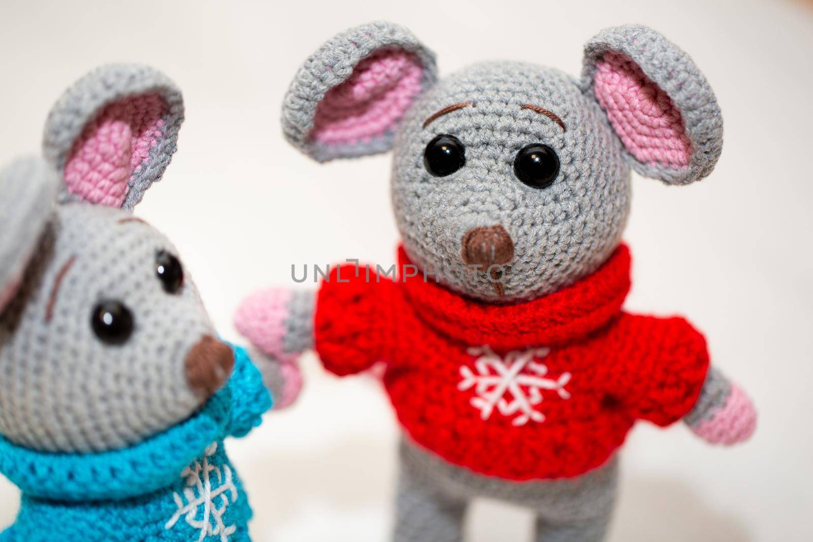 A knitted mouse. A soft toy as a symbol of the New Year.