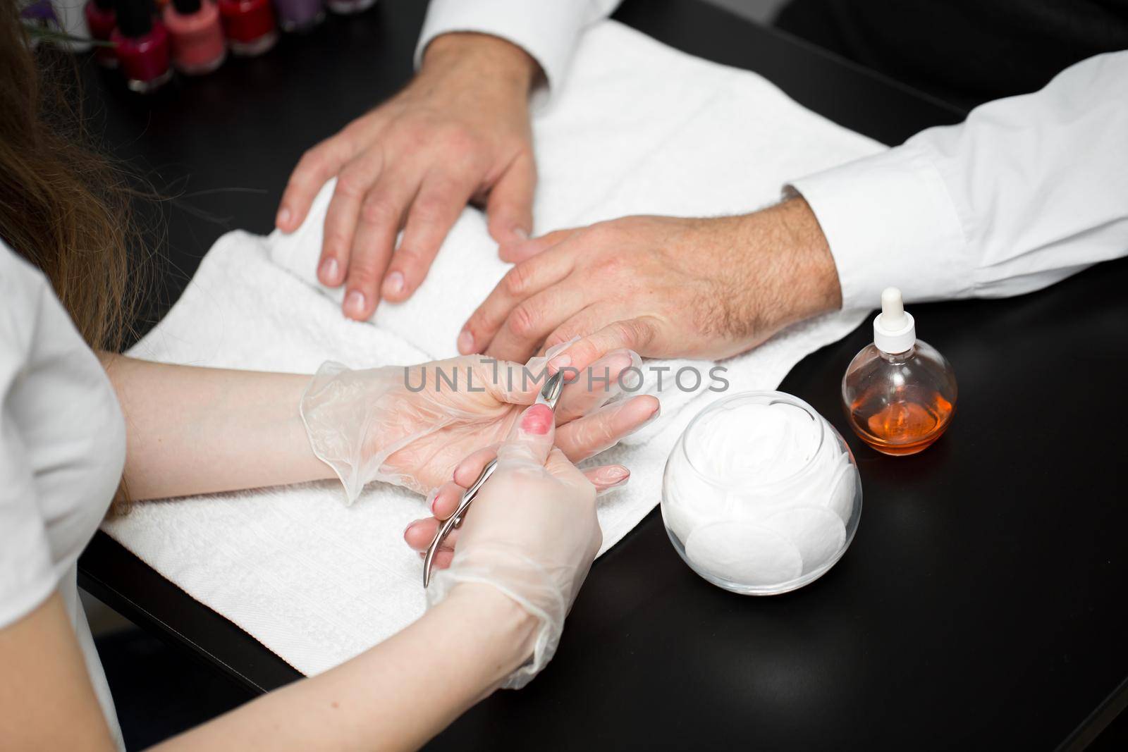 Close-up Of A Manicurist Cutting Off The Cuticle From The Person's Fingers. by StudioPeace