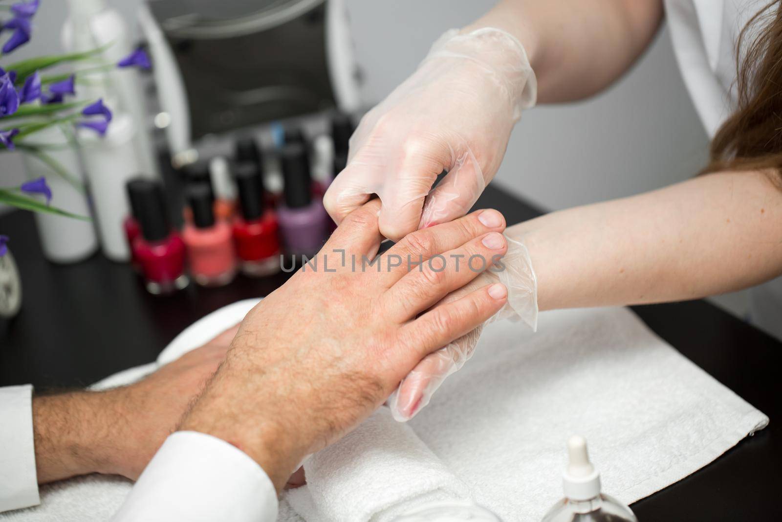 Massage after the manicure. Male and female hands macro.