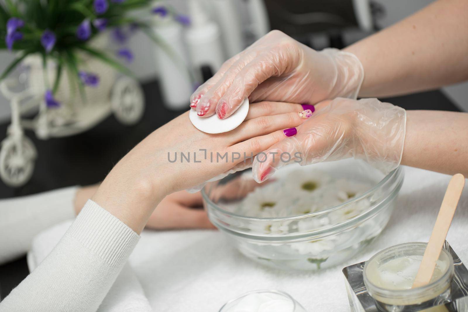 Woman is getting manicure in a beauty salon. Hands Spa. Manicure concept. by StudioPeace