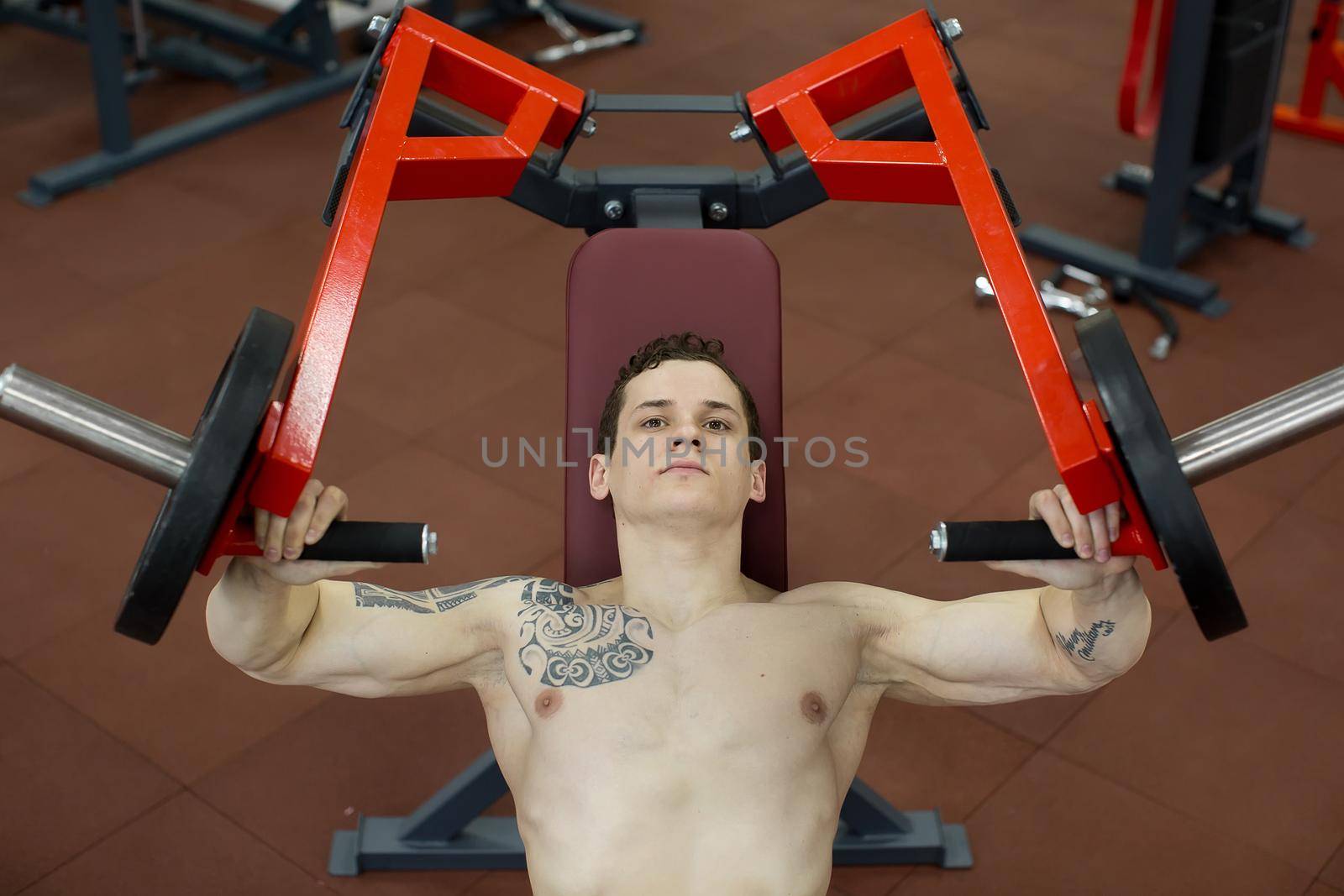 Man doing chest exercises on vertical bench press machine